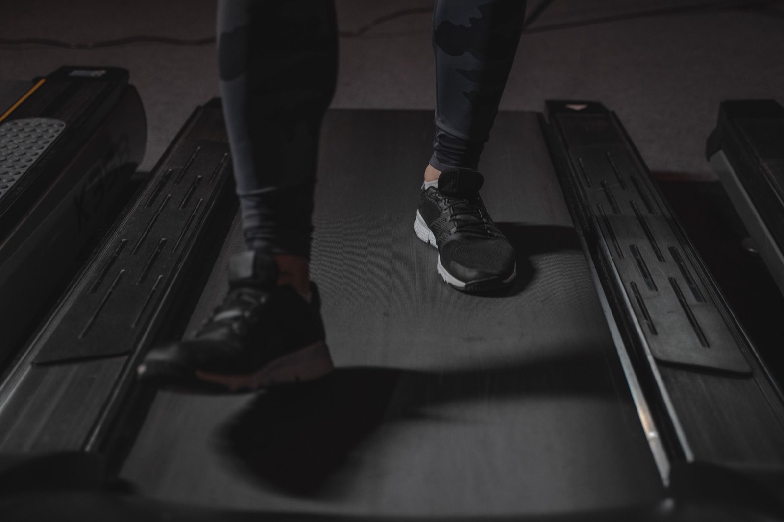 Sportif courant sur un tapis de course dans une salle de sport pour travailler son endurance